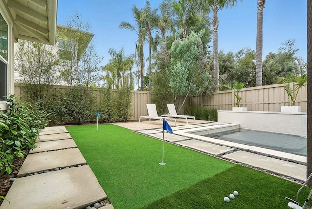 939 Moonstone Ct, Encinitas, CA 92024 - fenced backyard featuring a putting green and a patio