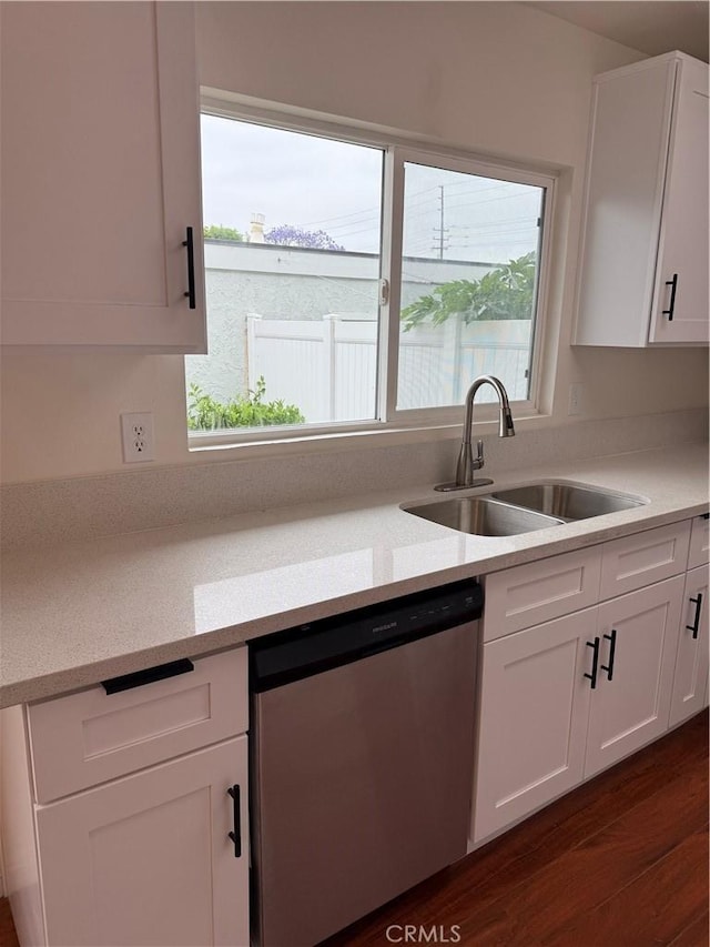 8537 Edgebrook Dr, Garden Grove, CA 92844 - kitchen with stainless steel dishwasher, a sink, white cabinets, and light countertops