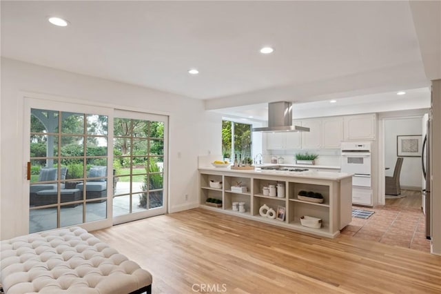 4947 Blackhorse Rd, Rancho Palos Verdes, CA 90275 - kitchen with white appliances, island exhaust hood, recessed lighting, open shelves, and light countertops