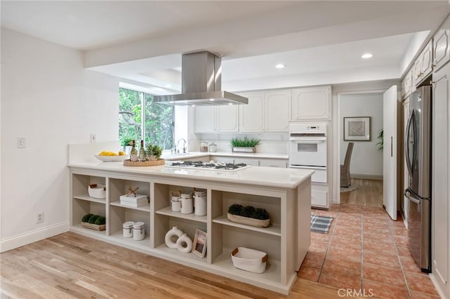 4947 Blackhorse Rd, Rancho Palos Verdes, CA 90275 - kitchen with white appliances, island range hood, open shelves, a sink, and light countertops
