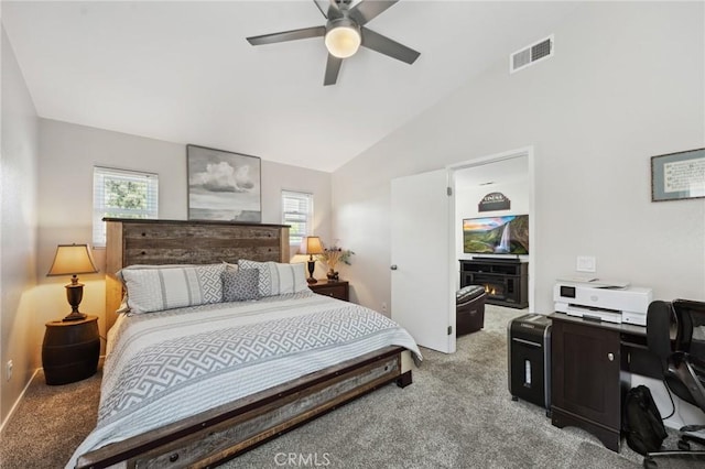 293 Belize Way, Oceanside, CA 92057 - carpeted bedroom featuring multiple windows, lofted ceiling, a warm lit fireplace, and a ceiling fan