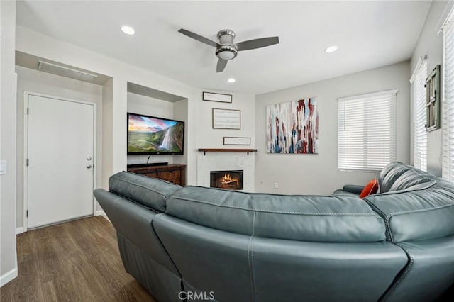 293 Belize Way, Oceanside, CA 92057 - living area with a ceiling fan, dark wood-style floors, a warm lit fireplace, and recessed lighting