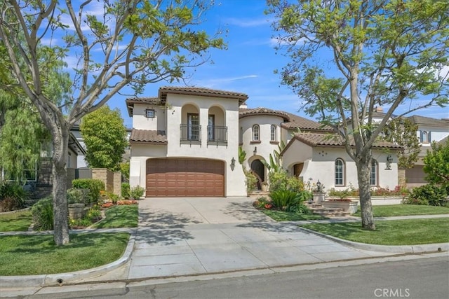 10 Edendale St, Ladera Ranch, CA 92694 - mediterranean / spanish-style home featuring stucco siding, a balcony, an attached garage, concrete driveway, and a tiled roof