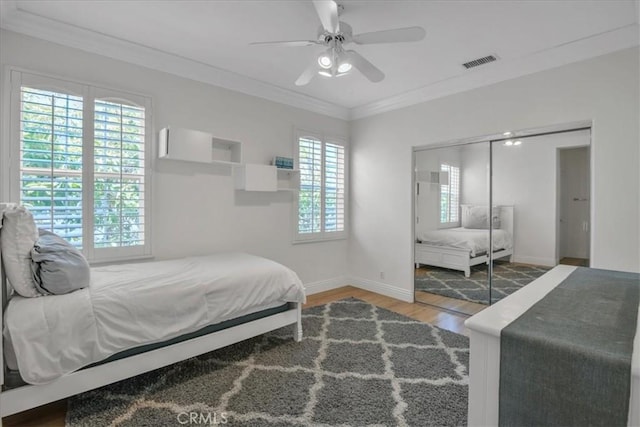 10 Edendale St, Ladera Ranch, CA 92694 - bedroom featuring wood finished floors, ornamental molding, baseboards, a ceiling fan, and a closet