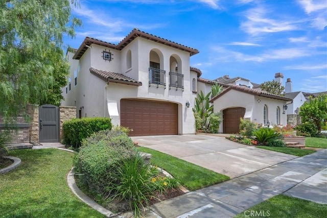 10 Edendale St, Ladera Ranch, CA 92694 - mediterranean / spanish-style house featuring a balcony, stucco siding, driveway, a tiled roof, and an attached garage