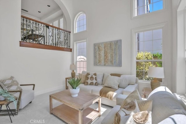 10 Edendale St, Ladera Ranch, CA 92694 - living room with a towering ceiling, plenty of natural light, carpet floors, and baseboards