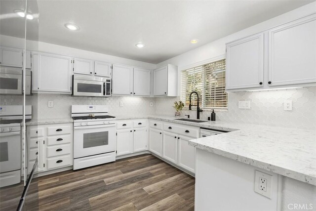 42192 Delmonte St, Temecula, CA 92591 - kitchen with stainless steel microwave, white gas range oven, a sink, light stone countertops, and recessed lighting