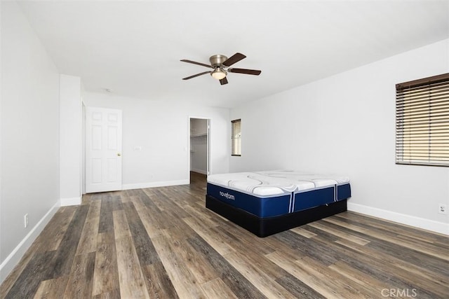 42192 Delmonte St, Temecula, CA 92591 - bedroom with dark wood-style flooring, baseboards, a ceiling fan, and a spacious closet