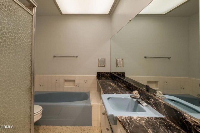 1000 Cordova St Unit 103, Pasadena, CA 91106 - full bathroom featuring vanity, a bath, speckle patterned floor, and toilet