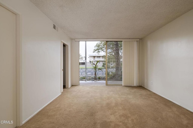 1000 Cordova St Unit 103, Pasadena, CA 91106 - empty room with a wall of windows, carpet floors, and a textured ceiling