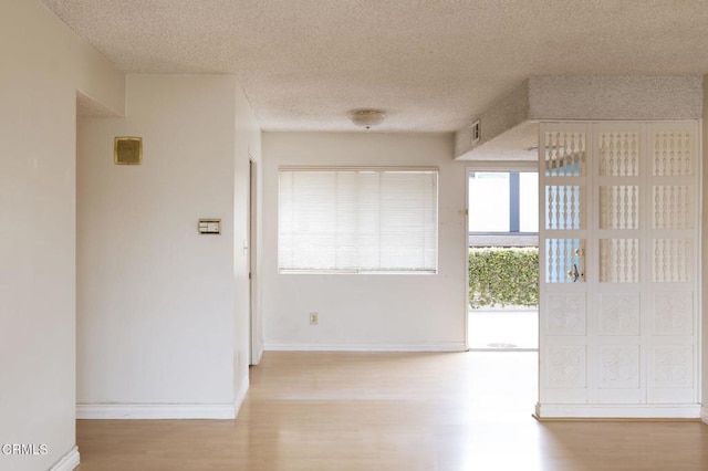 1000 Cordova St Unit 103, Pasadena, CA 91106 - hall featuring wood finished floors, a textured ceiling, and baseboards