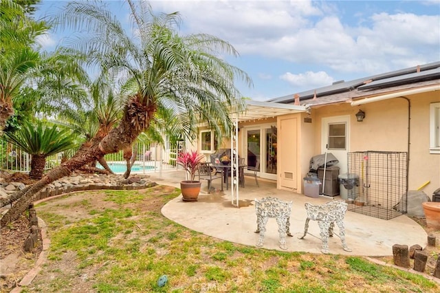 1528 E San Alto Ave, Orange, CA 92865 - back of house featuring stucco siding, a patio area, solar panels, and an outdoor pool