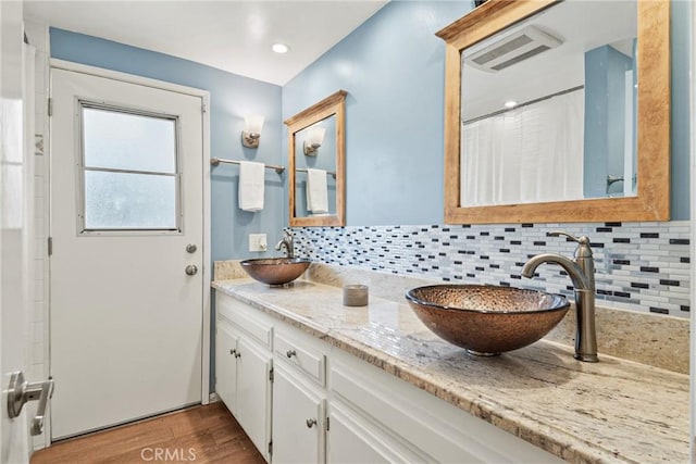 1528 E San Alto Ave, Orange, CA 92865 - bathroom with wood finished floors, double vanity, and backsplash