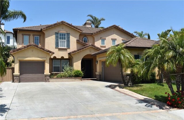 2437 N Eaton Ct, Orange, CA 92867 - mediterranean / spanish house featuring concrete driveway and stucco siding