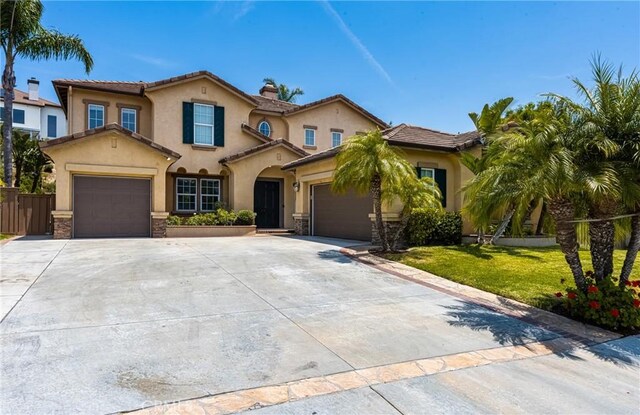 2437 N Eaton Ct, Orange, CA 92867 - mediterranean / spanish-style house featuring driveway, stucco siding, a garage, and a chimney