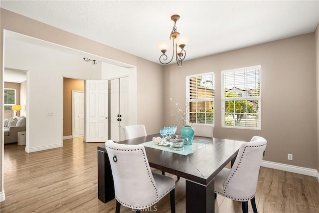 2437 N Eaton Ct, Orange, CA 92867 - dining area featuring light wood-style floors and a chandelier