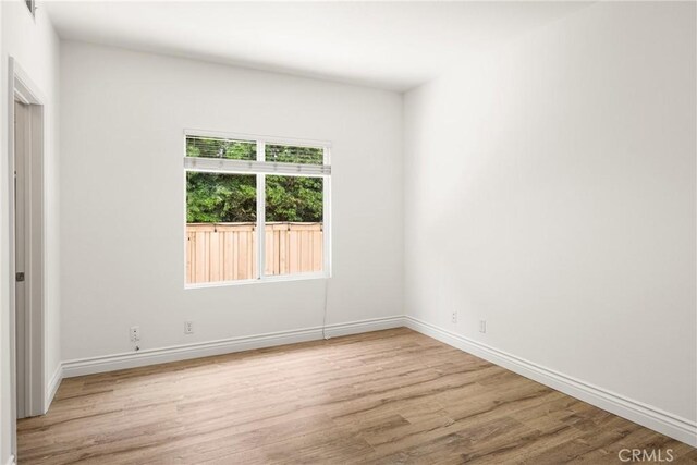2437 N Eaton Ct, Orange, CA 92867 - spare room featuring wood finished floors and baseboards