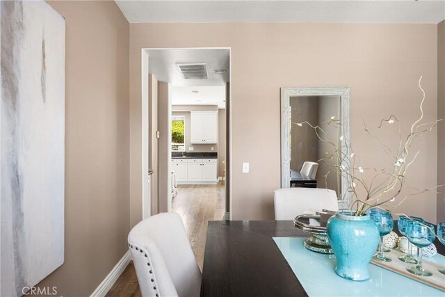 2437 N Eaton Ct, Orange, CA 92867 - dining space with light wood-style floors and baseboards