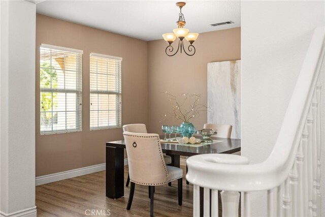 2437 N Eaton Ct, Orange, CA 92867 - dining space with plenty of natural light, wood finished floors, and a chandelier