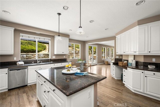 2437 N Eaton Ct, Orange, CA 92867 - kitchen with dishwasher, wood finished floors, white cabinetry, recessed lighting, and a textured ceiling