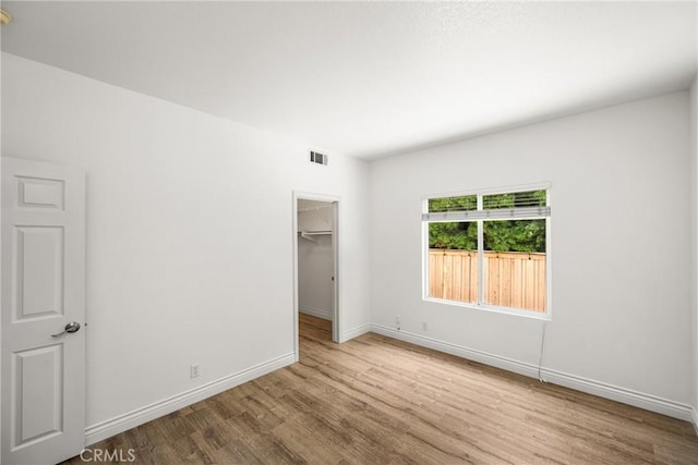 2437 N Eaton Ct, Orange, CA 92867 - unfurnished bedroom with wood finished floors, a spacious closet, and a closet
