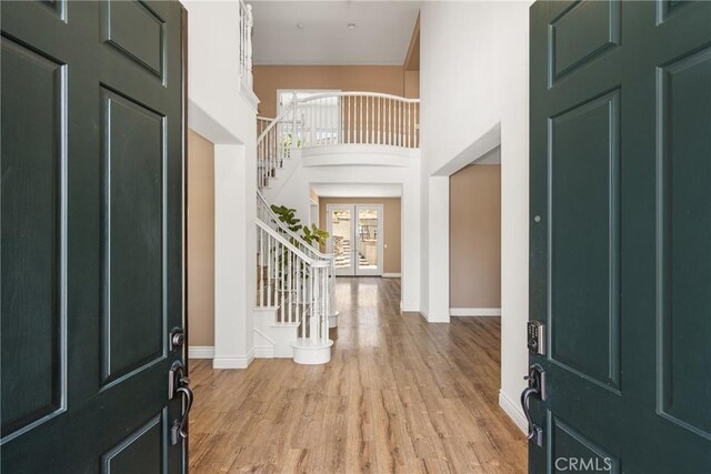 2437 N Eaton Ct, Orange, CA 92867 - foyer entrance with stairs, light wood finished floors, and a high ceiling