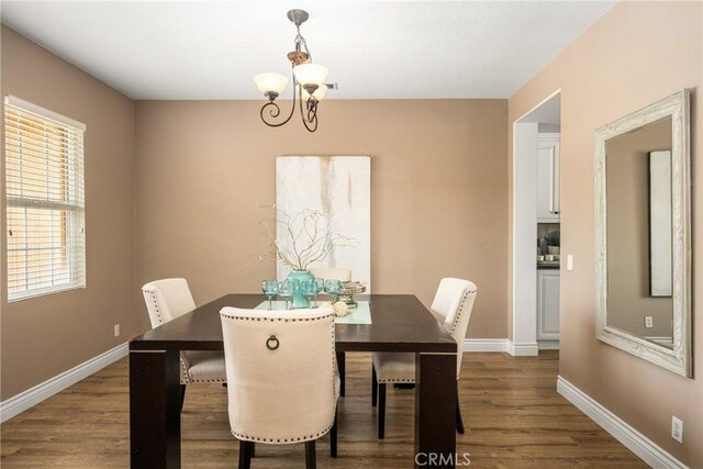 2437 N Eaton Ct, Orange, CA 92867 - dining room with dark wood-type flooring and a chandelier