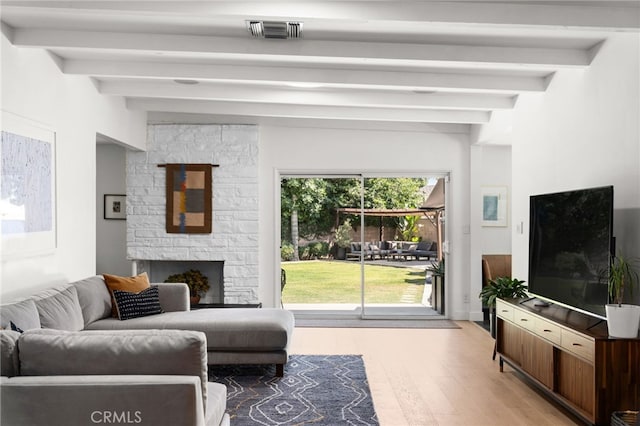 17949 Archwood St, Reseda, CA 91335 - living area with beamed ceiling, a fireplace, and light wood-style floors