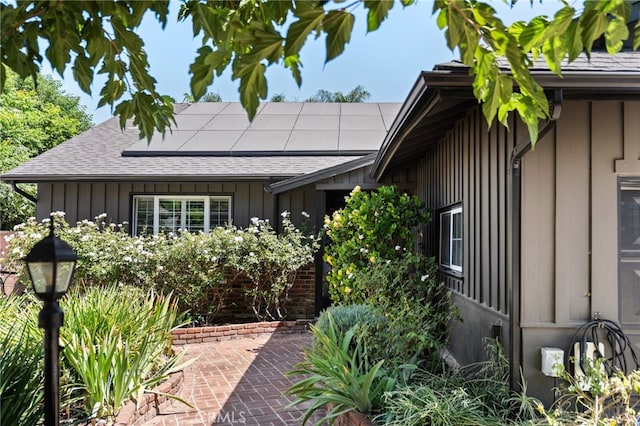 17949 Archwood St, Reseda, CA 91335 - view of front facade featuring board and batten siding, roof mounted solar panels, and roof with shingles