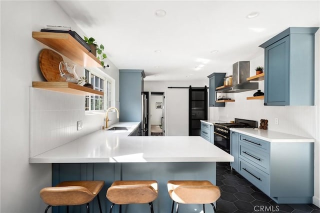 17949 Archwood St, Reseda, CA 91335 - kitchen featuring open shelves, gas stove, wall chimney range hood, a peninsula, and a barn door