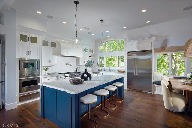 2 Royal Saint George Rd, Newport Beach, CA 92660 - kitchen with built in appliances, a warming drawer, glass insert cabinets, white cabinetry, and recessed lighting