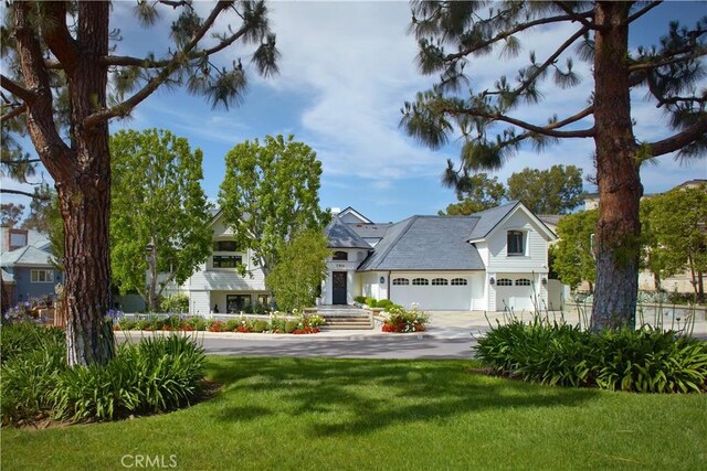2 Royal Saint George Rd, Newport Beach, CA 92660 - view of front of home featuring concrete driveway, a front yard, and an attached garage