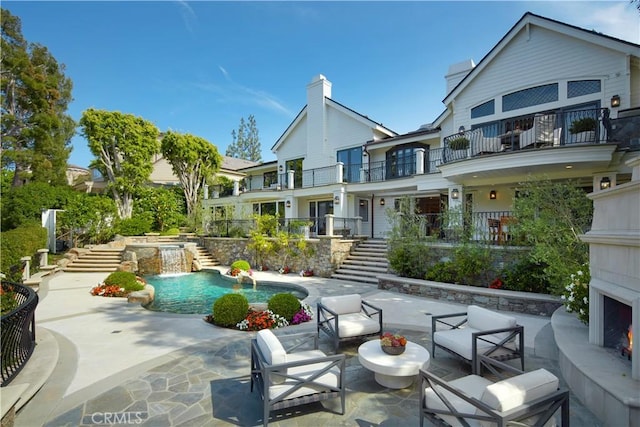 2 Royal Saint George Rd, Newport Beach, CA 92660 - back of property with stairway, a patio area, and a balcony