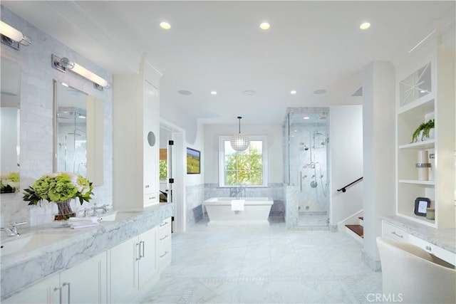 2 Royal Saint George Rd, Newport Beach, CA 92660 - bathroom with a shower stall, a freestanding tub, double vanity, recessed lighting, and built in features