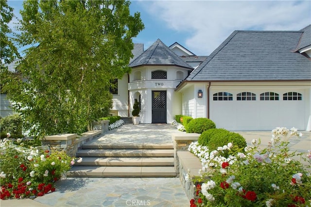 2 Royal Saint George Rd, Newport Beach, CA 92660 - view of front facade with a garage and stucco siding