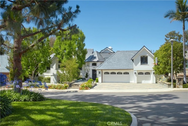 2 Royal Saint George Rd, Newport Beach, CA 92660 - view of front facade featuring concrete driveway and a garage