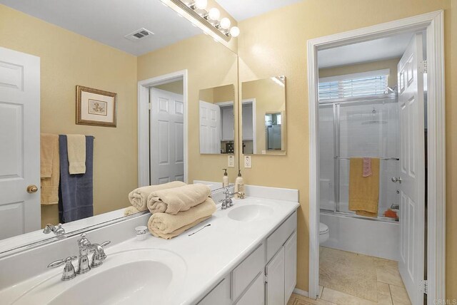 320 Corte Castillo, Chula Vista, CA 91914 - bathroom with double vanity, toilet, and enclosed tub / shower combo