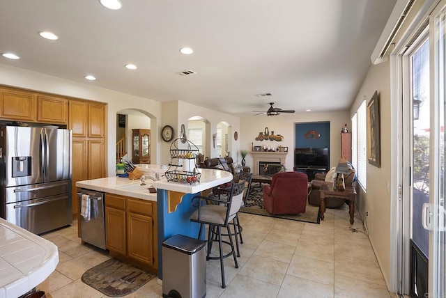 320 Corte Castillo, Chula Vista, CA 91914 - kitchen featuring appliances with stainless steel finishes, arched walkways, a ceiling fan, plenty of natural light, and recessed lighting