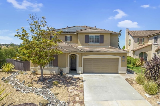 320 Corte Castillo, Chula Vista, CA 91914 - mediterranean / spanish house featuring stucco siding, a tile roof, driveway, an attached garage, and roof mounted solar panels