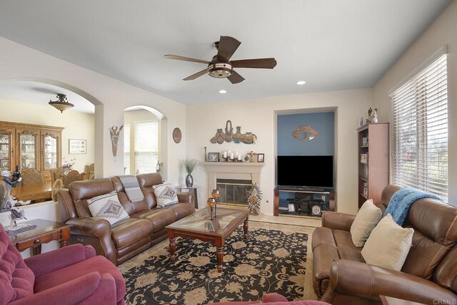 320 Corte Castillo, Chula Vista, CA 91914 - living area featuring arched walkways, ceiling fan, recessed lighting, and a glass covered fireplace