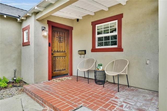 825 E Palm Ave, Monrovia, CA 91016 - view of exterior entry featuring stucco siding and a patio