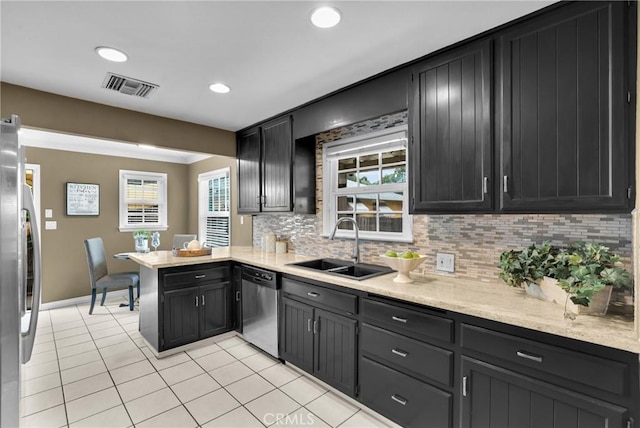 825 E Palm Ave, Monrovia, CA 91016 - kitchen featuring appliances with stainless steel finishes, a sink, a peninsula, tasteful backsplash, and light tile patterned floors