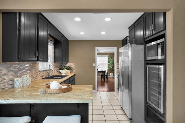 825 E Palm Ave, Monrovia, CA 91016 - kitchen featuring stainless steel appliances, a sink, beverage cooler, dark cabinetry, and light tile patterned floors