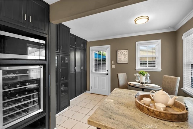 825 E Palm Ave, Monrovia, CA 91016 - kitchen featuring beverage cooler, dark cabinetry, stainless steel microwave, light tile patterned floors, and crown molding