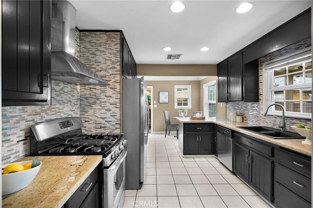 825 E Palm Ave, Monrovia, CA 91016 - kitchen with stainless steel appliances, wall chimney exhaust hood, a sink, light tile patterned flooring, and a peninsula