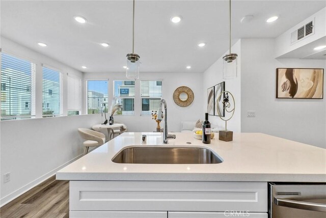 11047 Wander Dr, Rancho Cucamonga, CA 91730 - kitchen with a sink, stainless steel dishwasher, light wood-style flooring, white cabinets, and pendant lighting