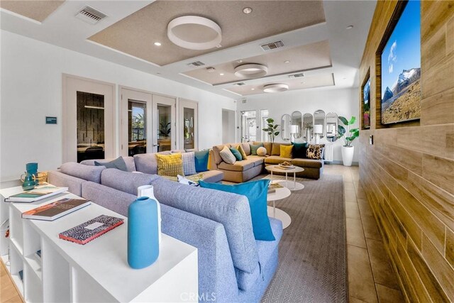 11047 Wander Dr, Rancho Cucamonga, CA 91730 - tiled living room featuring a tray ceiling, french doors, and recessed lighting