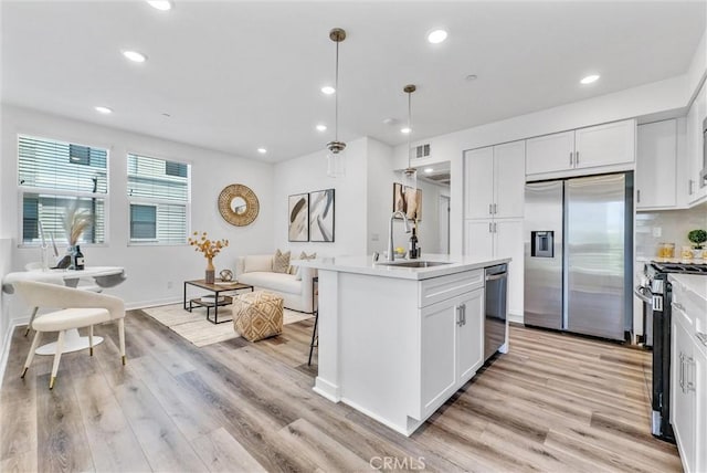 11047 Wander Dr, Rancho Cucamonga, CA 91730 - kitchen featuring appliances with stainless steel finishes, a sink, light countertops, recessed lighting, and light wood-style floors