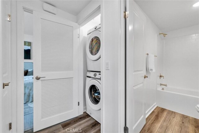 11047 Wander Dr, Rancho Cucamonga, CA 91730 - laundry area featuring estacked washer and dryer and wood finished floors
