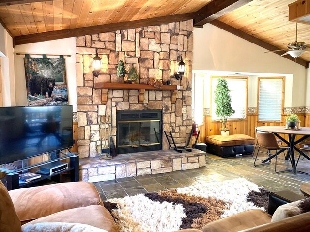 43133 Moonridge Rd, Big Bear, CA 92315 - living room with a wainscoted wall, wood ceiling, ceiling fan, a fireplace, and stone tile flooring